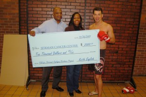 Rep. Keith English, D-68, giving $2,000 worth of winnings from a fight to the Siteman Cancer Center (Submitted photo)