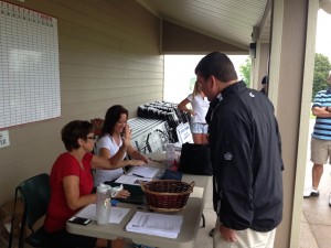 Tournament players register for the Sifford Scramble Friday morning. (Photo by Collin Reischman)