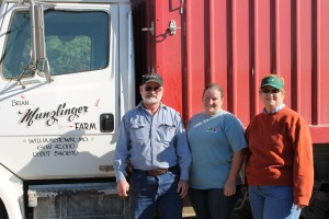 Munzlinger, his daughter Lea and wife, Michele pose for a photo by their family truck. (photo by Ashley Jost)