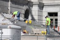 Construction crews work to lay the old marble stones back in place on the front steps of the Capitol in Jefferson City. (Benjamin Peters/The Missouri Times)